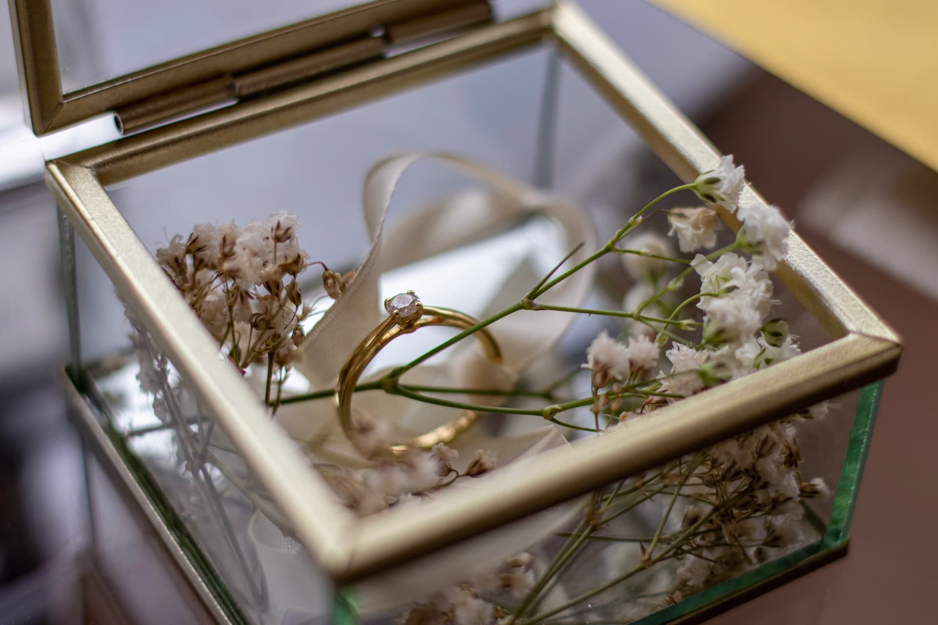 Wedding ring in a glass box with baby's breath
